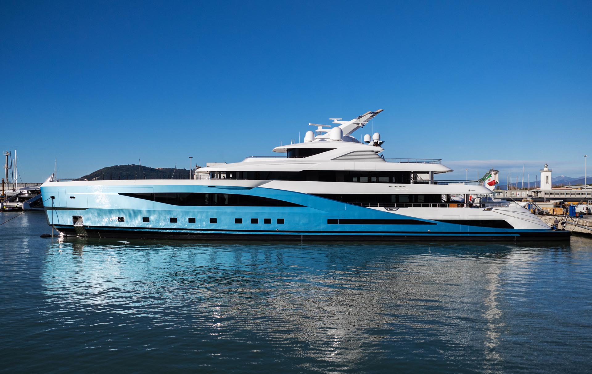 Detailed view of the angular superstructure of the 78-meter Admiral megayacht, highlighting the crisp lines and the contrast between the white finish and the metallic blue hull.